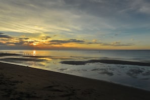 Enjoy a tranquil beach experience with calm waters and serene surroundings.
