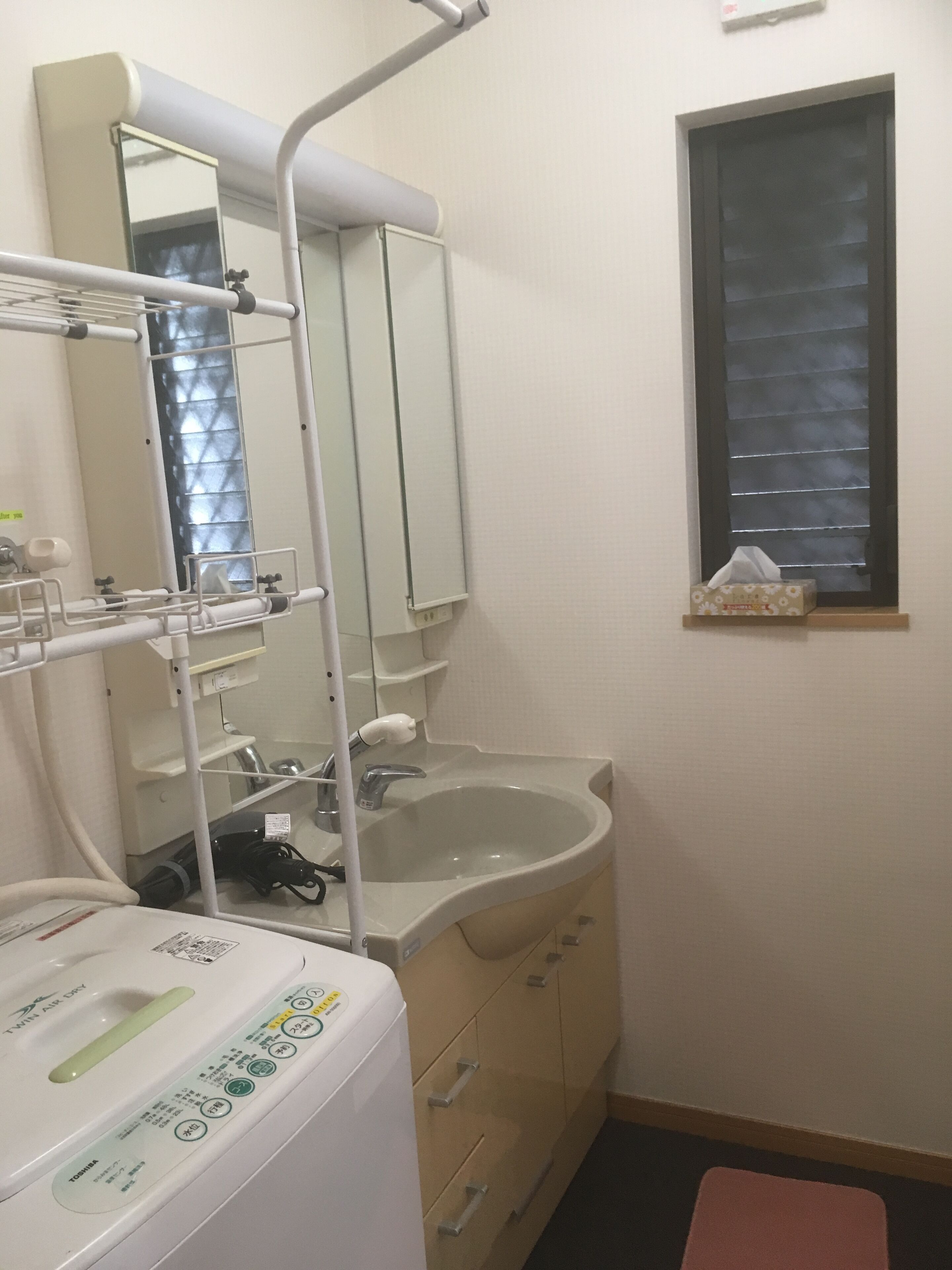 Bathtub, hair dryer, towels, toilet paper