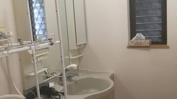 Bathtub, hair dryer, towels, toilet paper