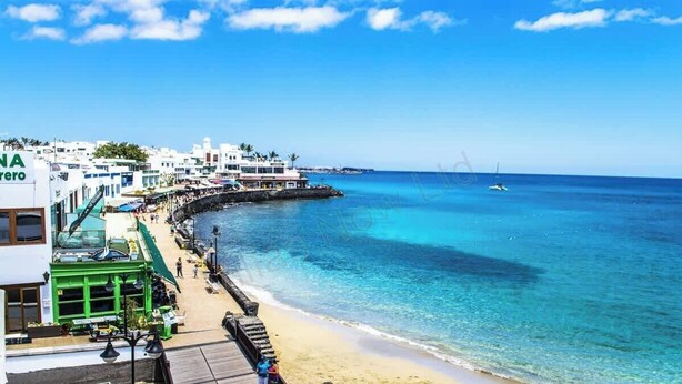 A coastal hotel with a beach view, a pier, and a boat dock. - Vista Maritima 1B - Seafront Stay by Villas Now (Playa Blanca)