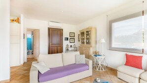 A living room with a sofa, a smaller couch, a coffee table, and a view of the outside. - 4 km from Porto Cervo with panoramic terrace (Abbiadori)