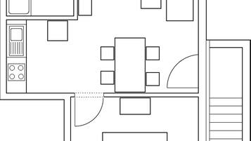 A floor plan with a kitchen, dining area, and a large living room.