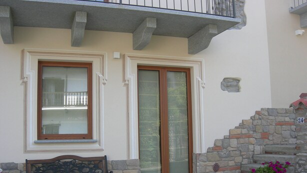 A building with a stone staircase, a bench, and a door with a glass panel. - NEW HOLIDAY HOUSE (Garessio (Cn))