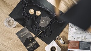 A black bag with a map, a coffee cup, and a pair of earrings on a wooden surface. - 2 bedrooms, kitchen, bathroom, next to the valley run and the valley station (Kaltenbach)