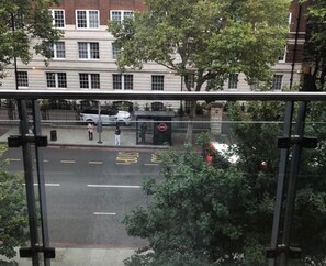 Overlooking a bustling street scene with marked lanes and a pedestrian crossing.