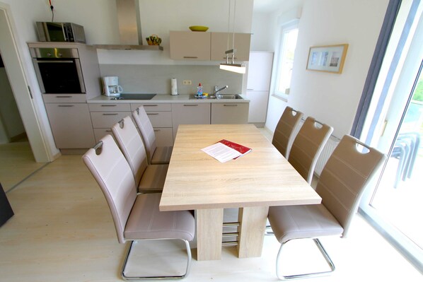 A modern kitchen with a dining area.