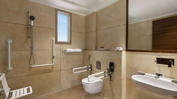 Un baño moderno con inodoro, ducha y lavamanos.