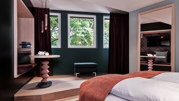 A modern bedroom with a bed, a desk, a chair, and a TV.