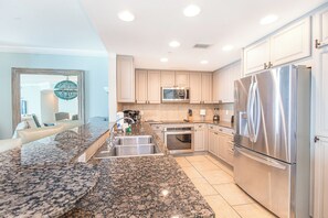 Enjoy cooking in this well-equipped kitchen with a refrigerator, oven, and microwave.