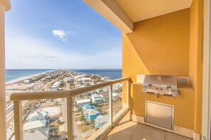Enjoy stunning beach views from this balcony with a barbecue grill.