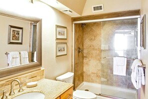 A bathroom with a shower, toilet, sink, and a large mirror. - Sandpiper Condominiums 1007L, Panoramic Gulf View w/ direct access to Mustang Island/Port A beaches. (Port Aransas)