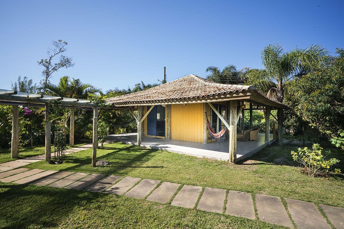 A small, single-story house with a tiled roof and a covered porch.