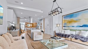 A modern living room with a glass coffee table, a sofa, and a large abstract painting. -  Blissful Coral Villa EcoPool4b-4b (Miami)