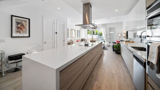 A modern kitchen with a large island, stainless steel appliances, and a minimalist design. -  Blissful Coral Villa EcoPool4b-4b (Miami)