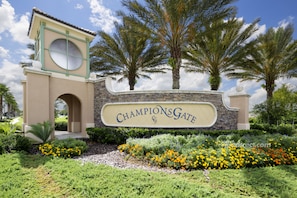 Welcome to ChampionsGate, surrounded by lush greenery and palm trees.