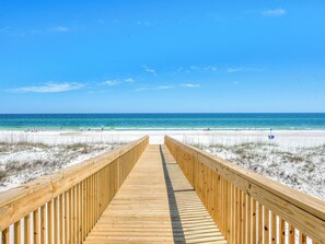 A wooden boardwalk leading to a beach with clear skies. - 🥳 Early Bird Sale. First 2! Wits End, East. 6BR. Pool. Awesome 2nd floor beach walkover! (Gulf Shores)