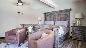 A bedroom with a large bed, two armchairs, a nightstand, and a dresser. - Spacious Mesa Oasis with FREE Heated POOL (Mesa)