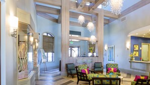 A spacious lobby with high ceilings, wooden beams, and a mix of seating areas including chairs and sofas. - Mickeys Hideaway by VillaDirect (Davenport)