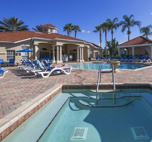 A pool area with lounge chairs, a sign for restrooms, and palm trees. - Minnies Emerald by VillaDirect (Kissimmee)
