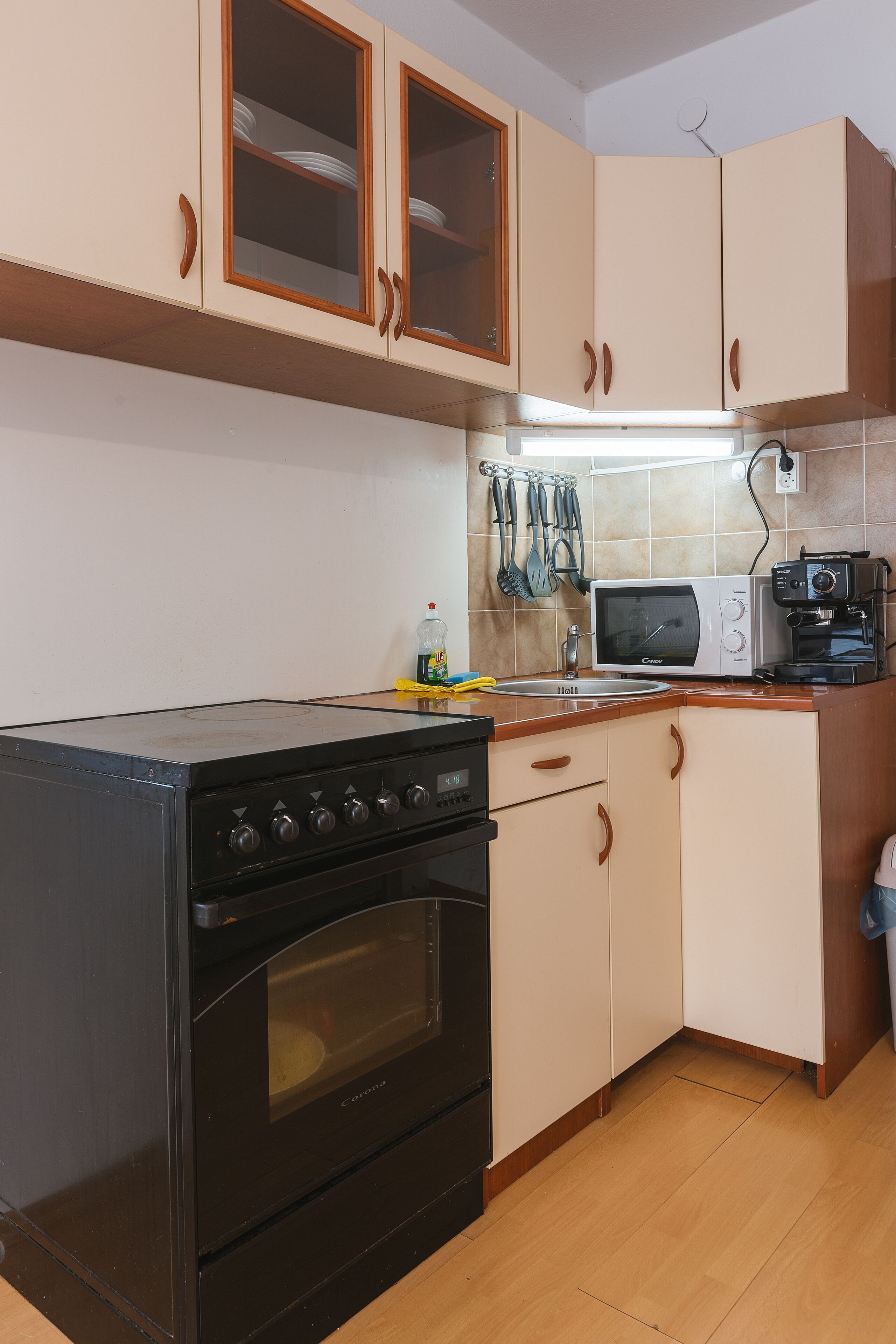 A kitchen with a stove, oven, microwave, and coffee maker.