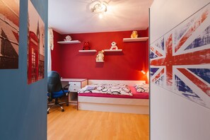 Cozy retreat with a comfortable bed, desk, and shelves for a productive stay.