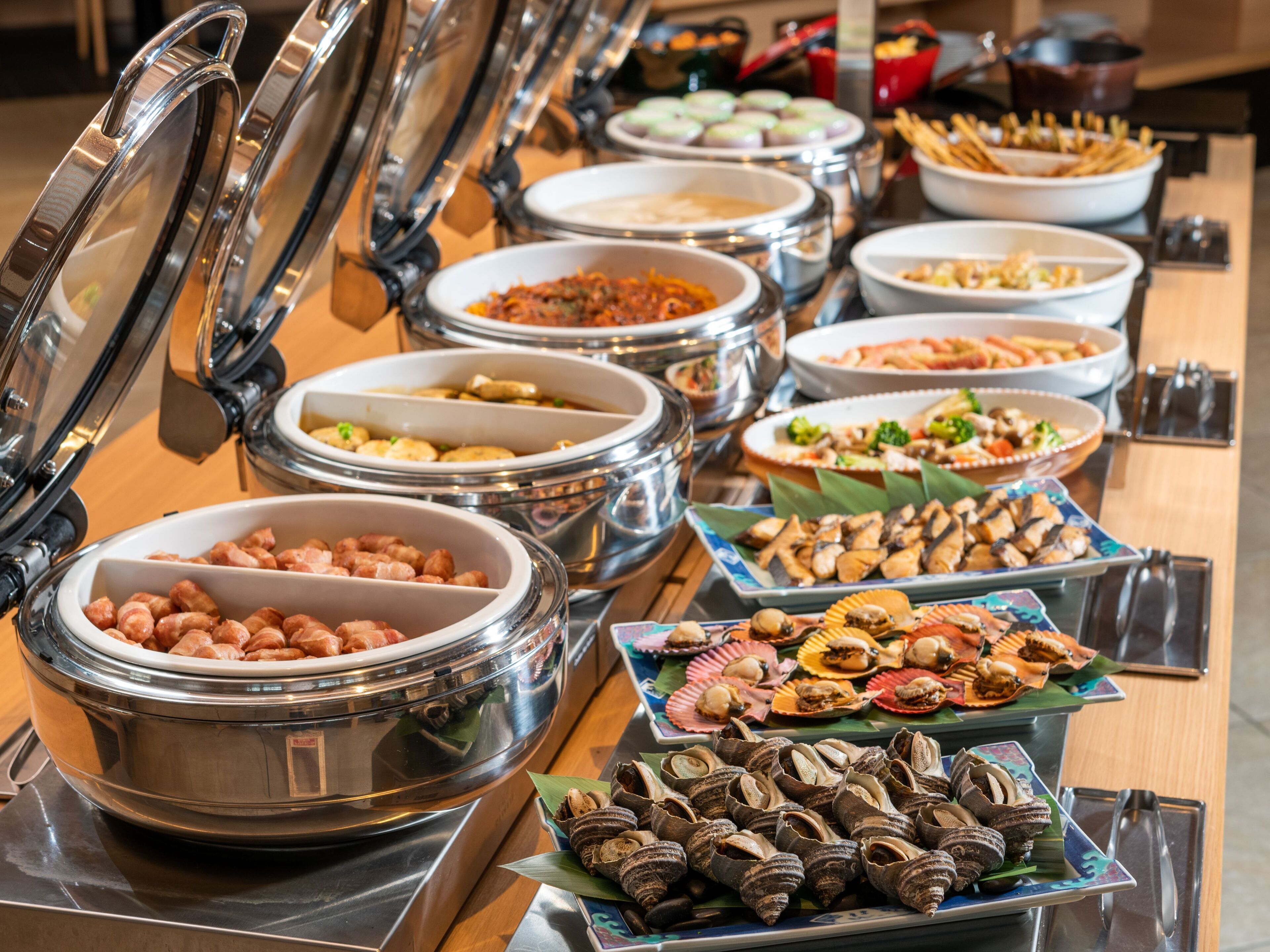 A buffet with various food items and containers.