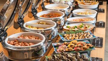 A buffet with various food items and containers.