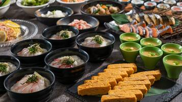 A variety of dishes including sashimi, tofu, and sushi on a wooden table.