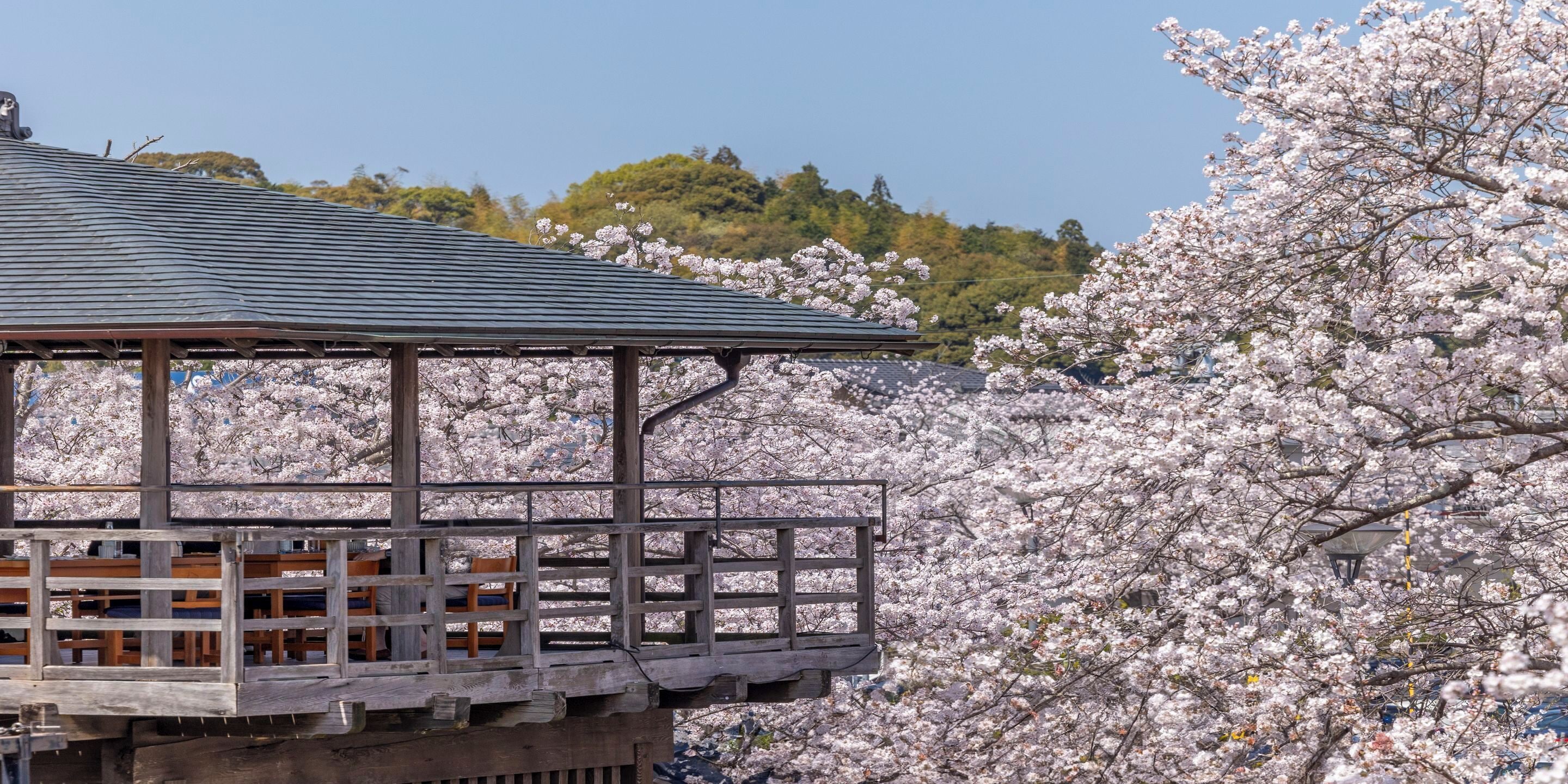 A traditional Japanese building with a wooden structure and a tiled roof.
