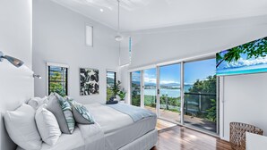 A modern bedroom with a large bed, a view of the outdoors, and a balcony. - Mandalay Escape Serenity and Pool (Mandalay)
