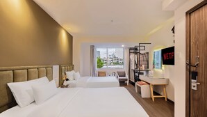 A hotel room with two beds, a desk, a chair, a TV, and a view of the city. - A25 Premium Hotel - 55 Le Anh Xuan (Ho Chi Minh City)