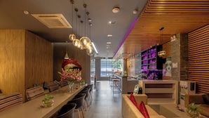 A modern hotel lobby with a long reception desk, seating area, and a bar. - A25 Premium Hotel - 55 Le Anh Xuan (Ho Chi Minh City)