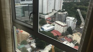 A view from a window overlooking a cityscape with high-rise buildings, construction cranes, and a mix of residential and commercial structures. - 27th Flr Condo1 w/WIFI @ IT Park Avida Riala Twrs (Cebu City)