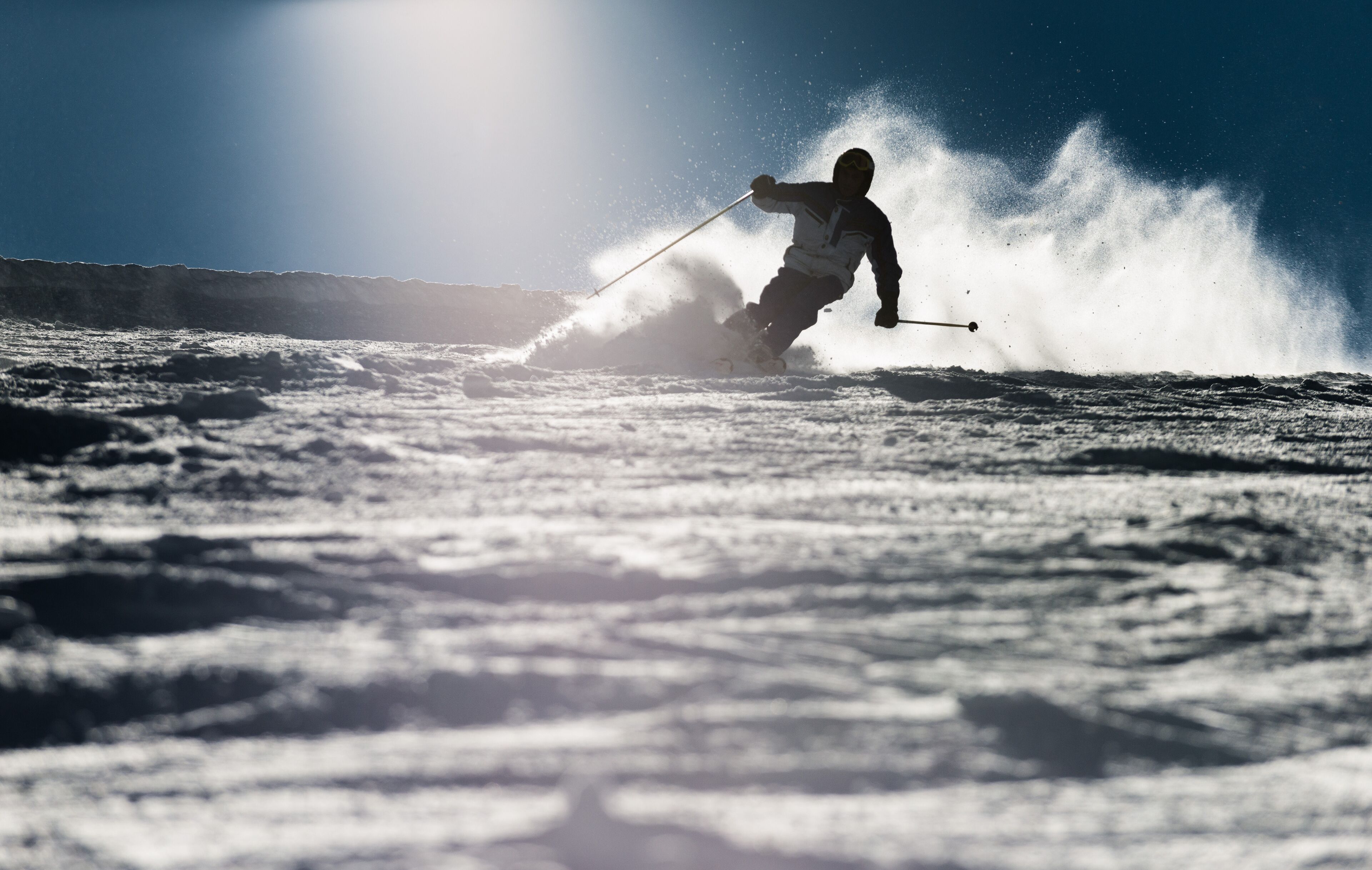 A person skiing down a snowy slope.