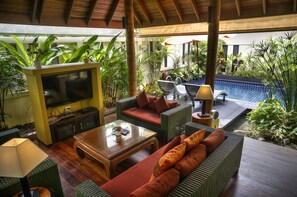 Superior Villa | Living area | 50-inch flat-screen TV with satellite channels, TV, DVD player