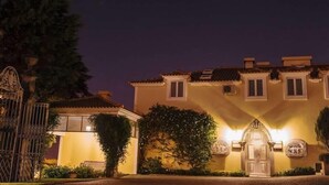 A multi-story building with a traditional architectural style, featuring a central entrance with a decorative archway and a gated driveway. - Hotel Rural Quinta da Vista Alegre (Pacos De Ferreira)