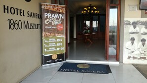 The entrance of Hotel Savera with a signboard advertising a Prawn Fest. - Hotel Savera (Chatworth)
