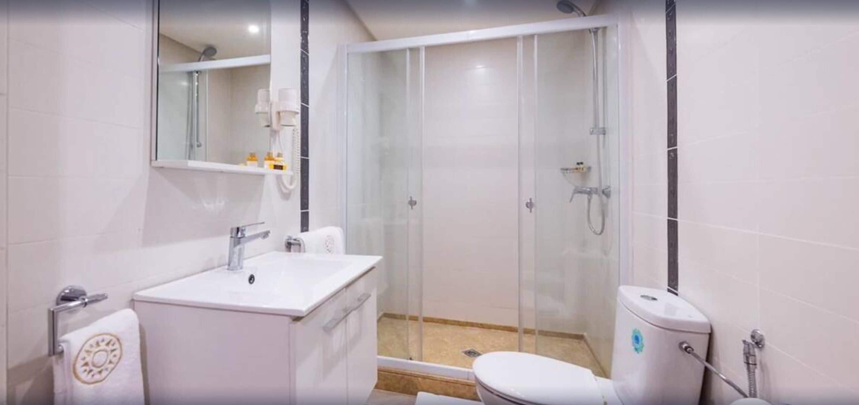 shower, rainfall showerhead, hair dryer, towels