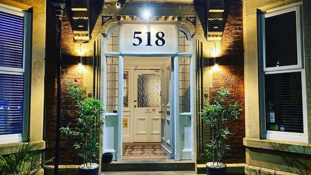 The entrance to a building with a number sign '518' above the door. - St Andrews House Hotel (Preston)