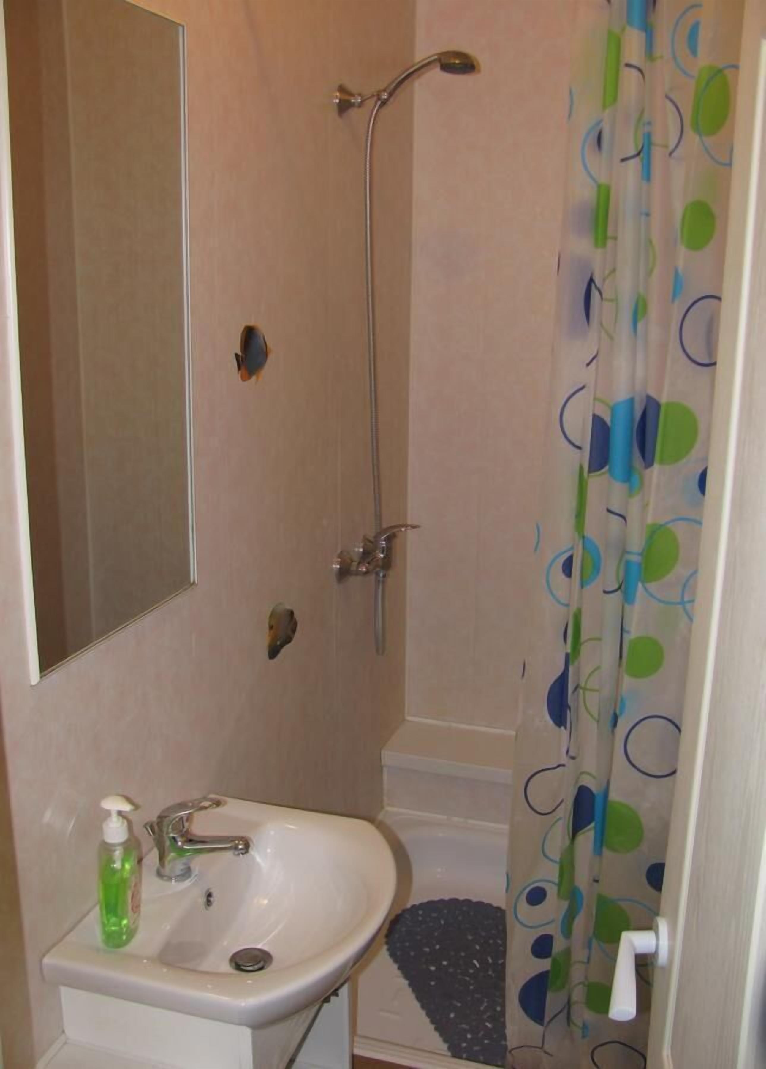 Shower, hair dryer, slippers, towels