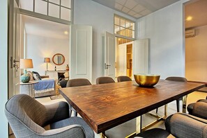 Un comedor moderno con una mesa de madera, seis sillas y un cuenco grande como centro de mesa.