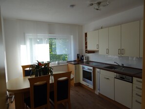 Fridge, stovetop, dishwasher, coffee/tea maker