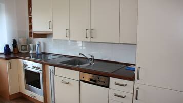 Fridge, stovetop, dishwasher, coffee/tea maker