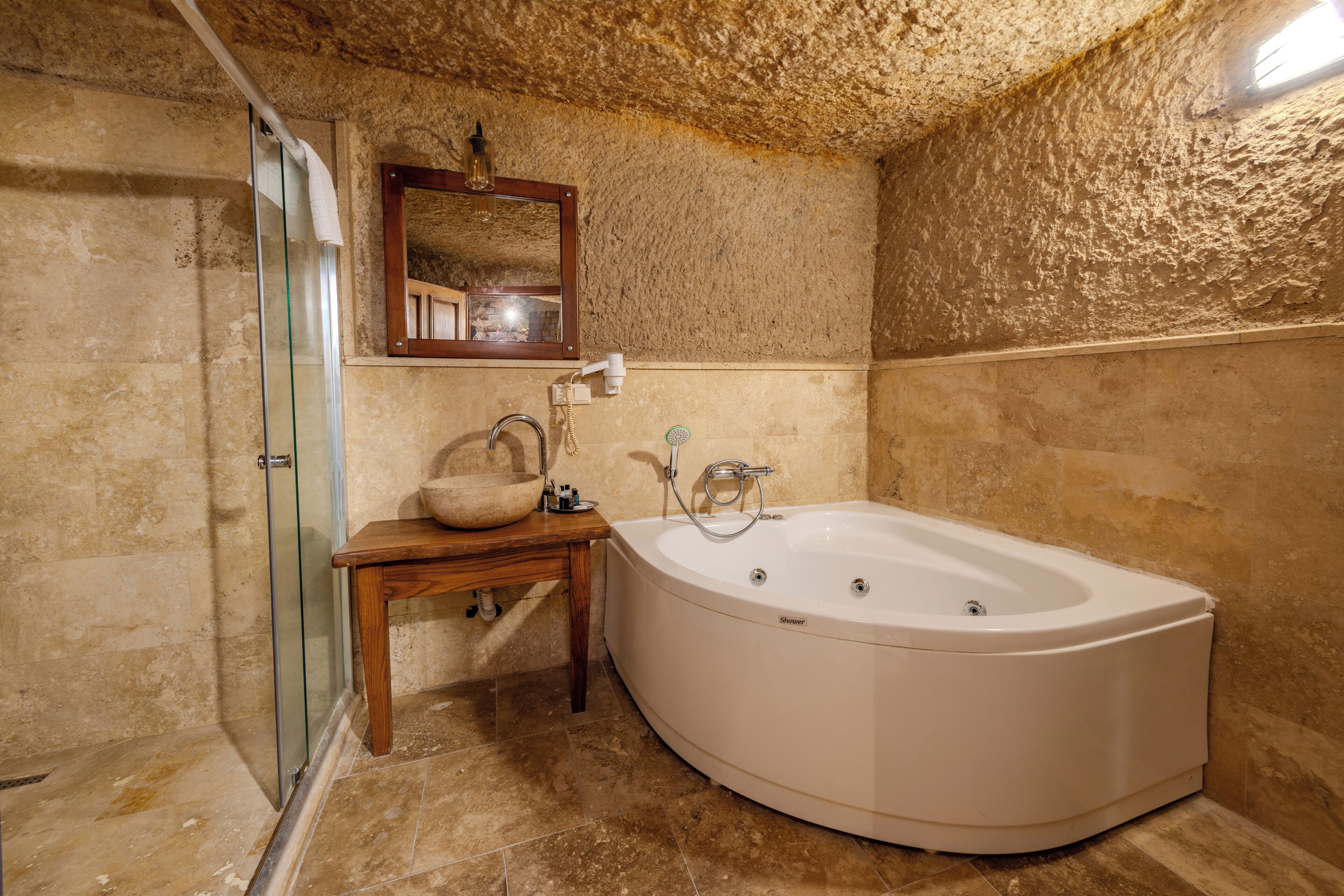 cave room, jacuzzi | bathroom | free toiletries, hair dryer, bathrobes, slippers
