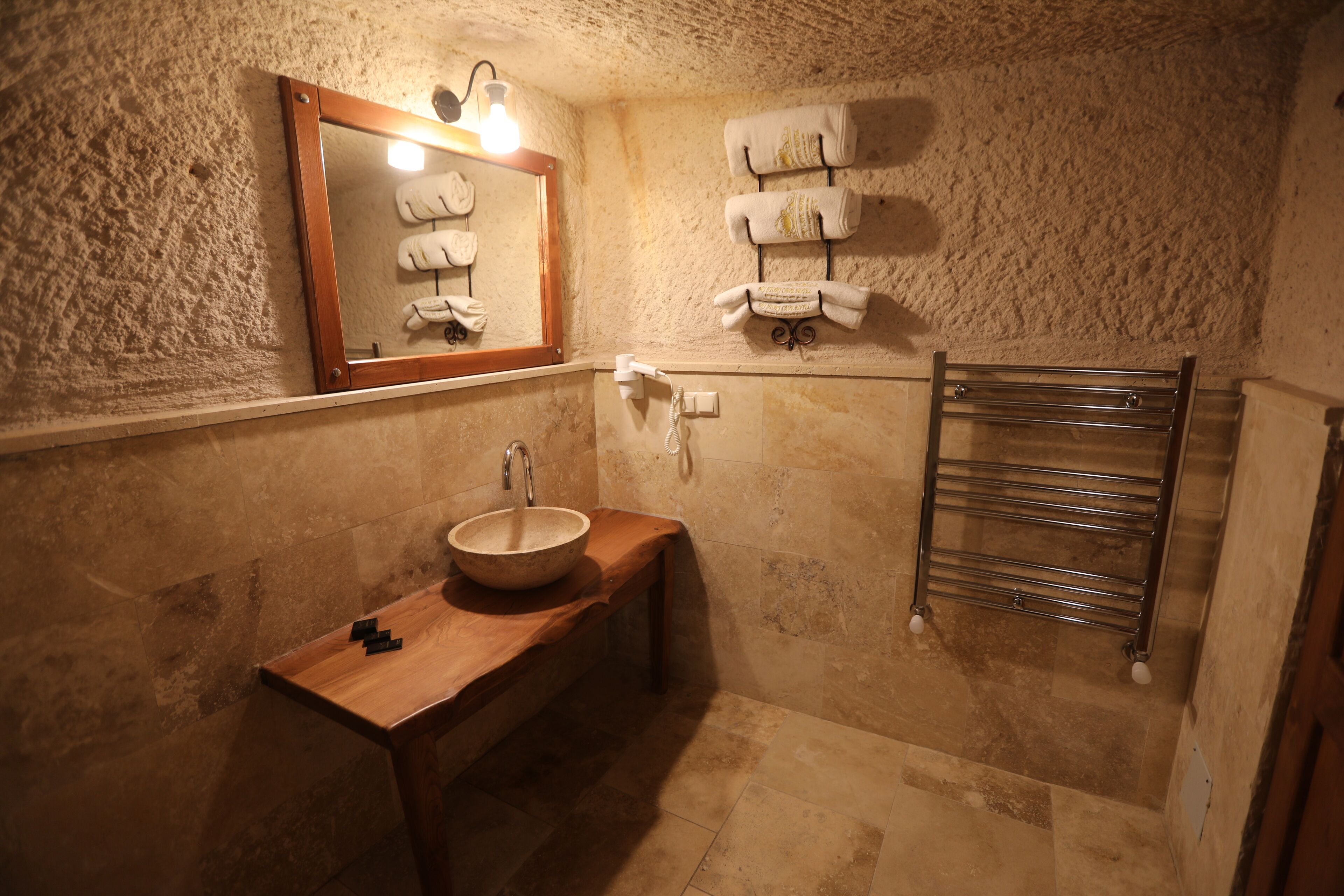deluxe cave room | bathroom | free toiletries, hair dryer, bathrobes, slippers