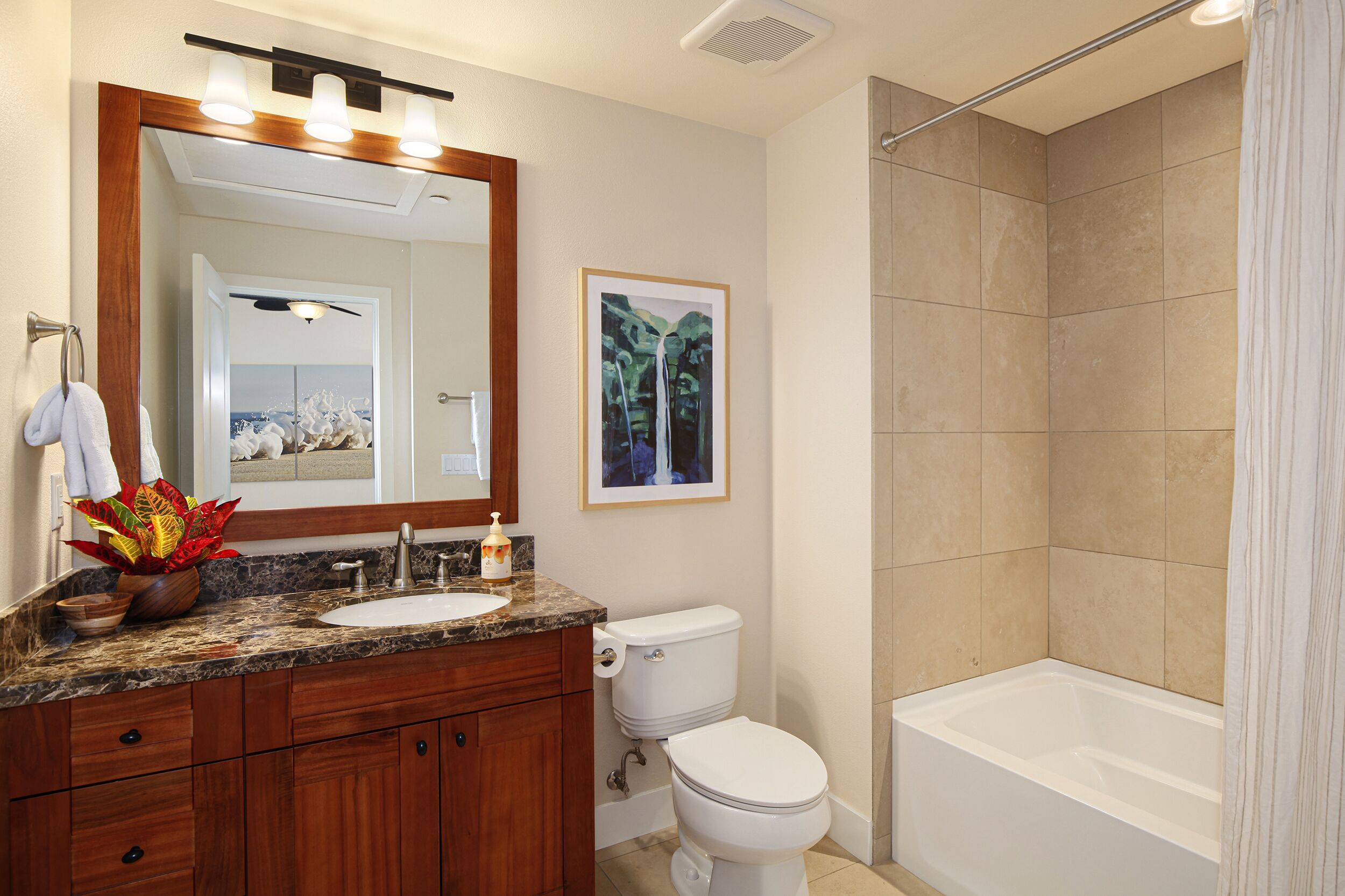 A bathroom with a sink, toilet, and bathtub.