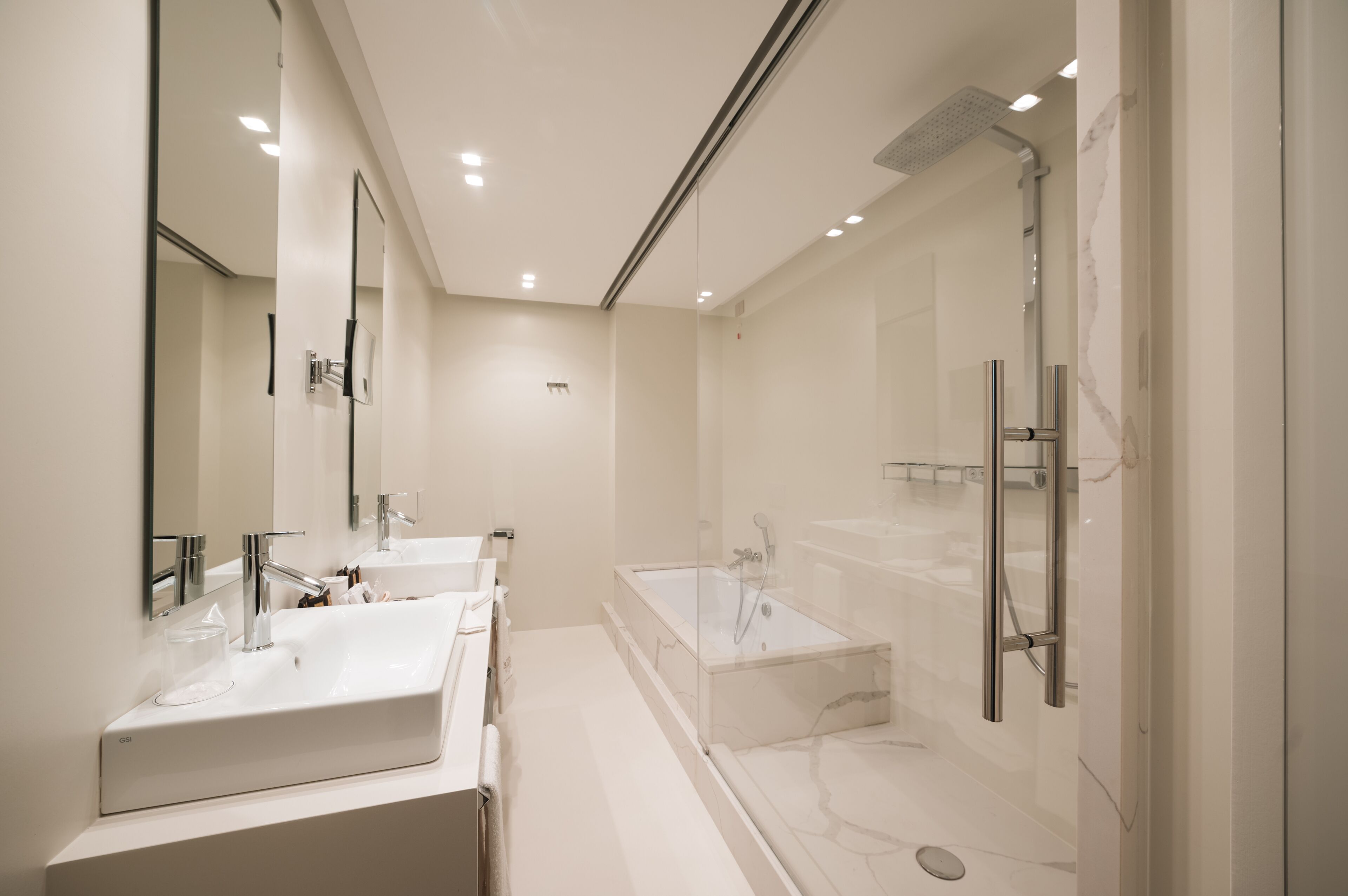 luxury king room | bathroom | designer toiletries, hair dryer, bathrobes, slippers