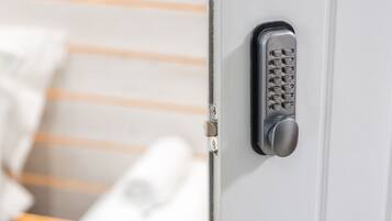 A close-up of a keypad lock on a door, likely for a hotel room.