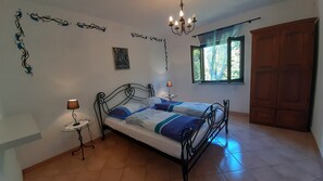 A bedroom with a bed, a chandelier, a window, and a wardrobe. - Villa Linet (Funtana)