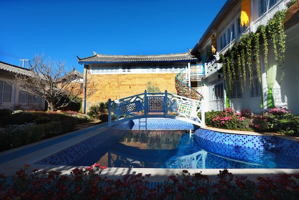 Seasonal outdoor pool, open noon to 6:00 PM, pool umbrellas